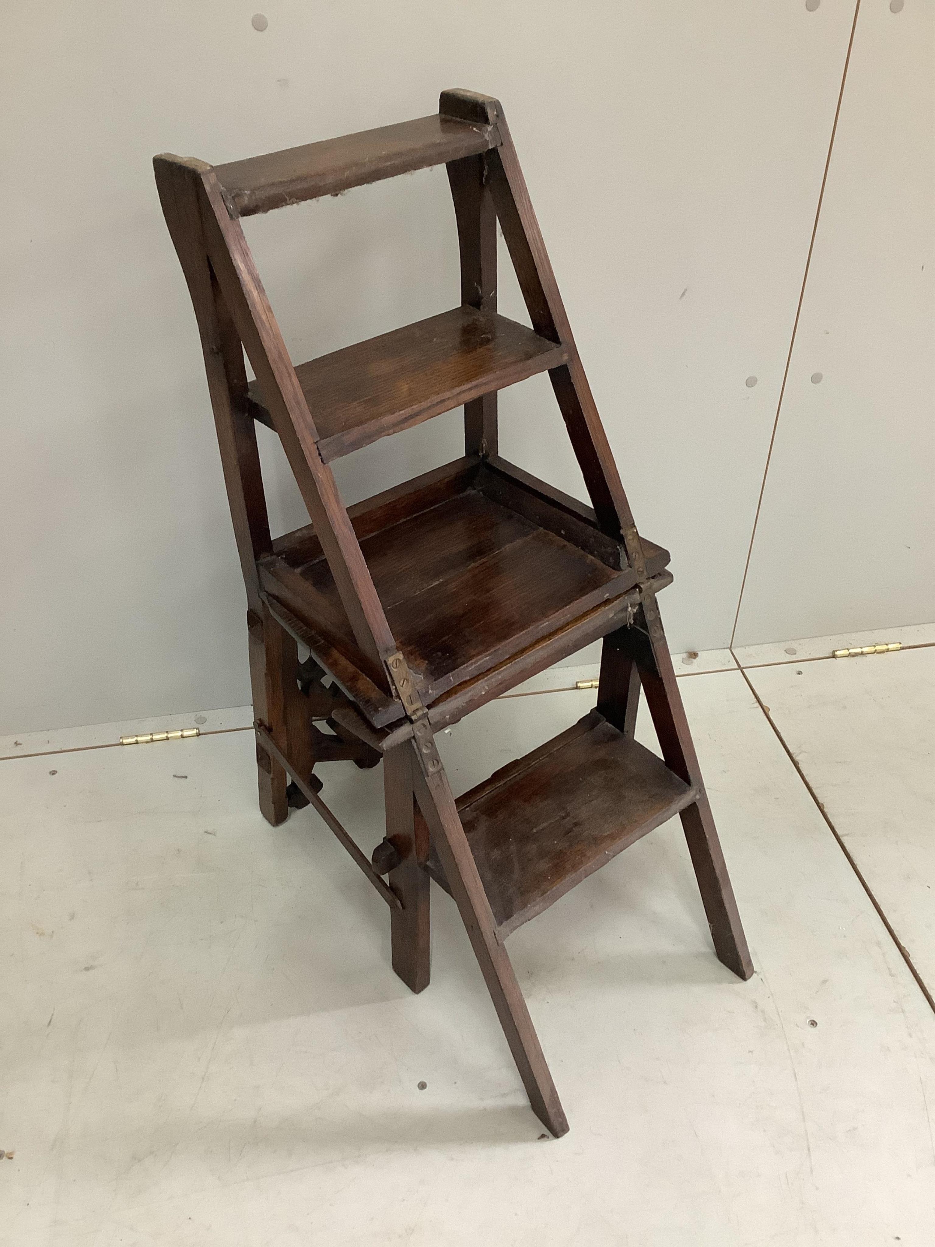 A Victorian Gothic Revival oak metamorphic library chair, width 40cm, depth 35cm, height 85cm. Condition - fair